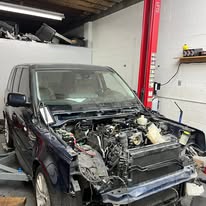 Workshop bay and lifted vehicle